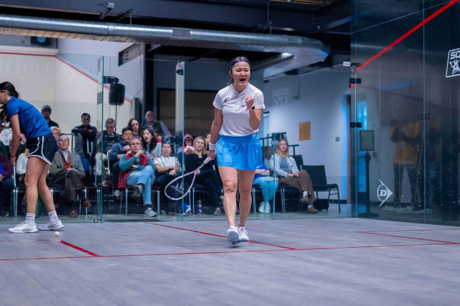 Satomi Watanabe celebrates winning the crucial second game against Nadien Elhammamy