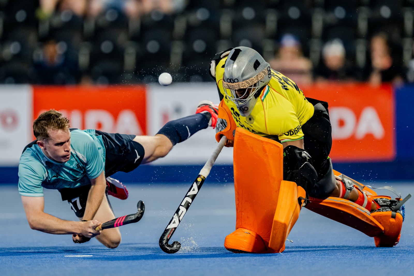 Indian goalie thwarts an England player from scoring