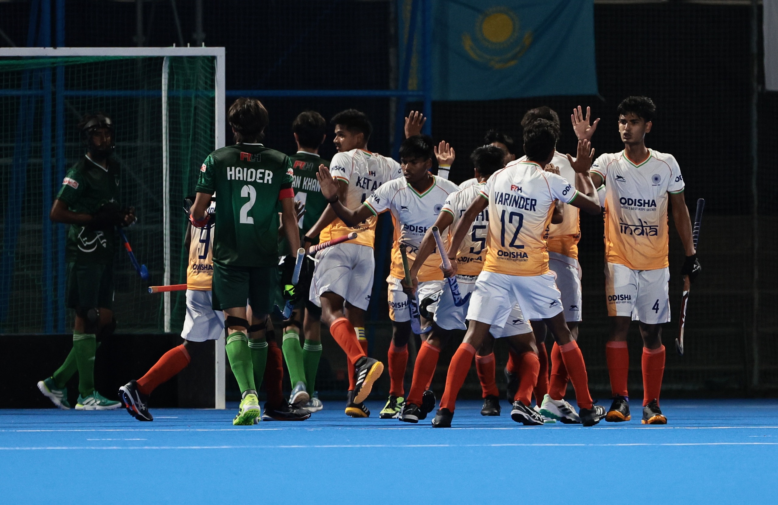 Indian men celebrate a goal against Pakistan