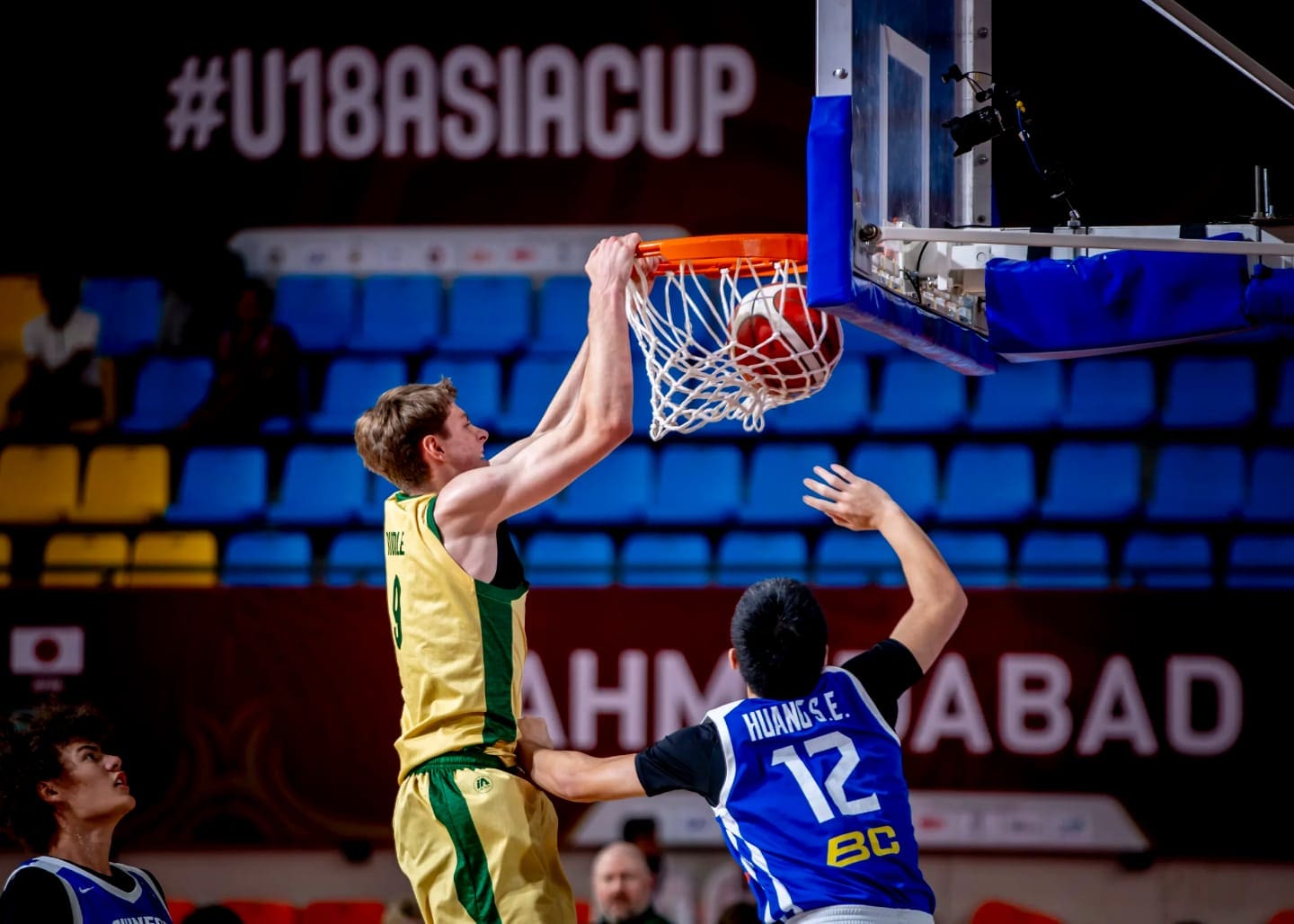 Isaac Riddle of Australia dunks the ball against Chinese Taipei