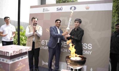 Chess Olympiad ceremonial Torch handed to Uzbek GM Javokhir Sindarov by Anand and Narang