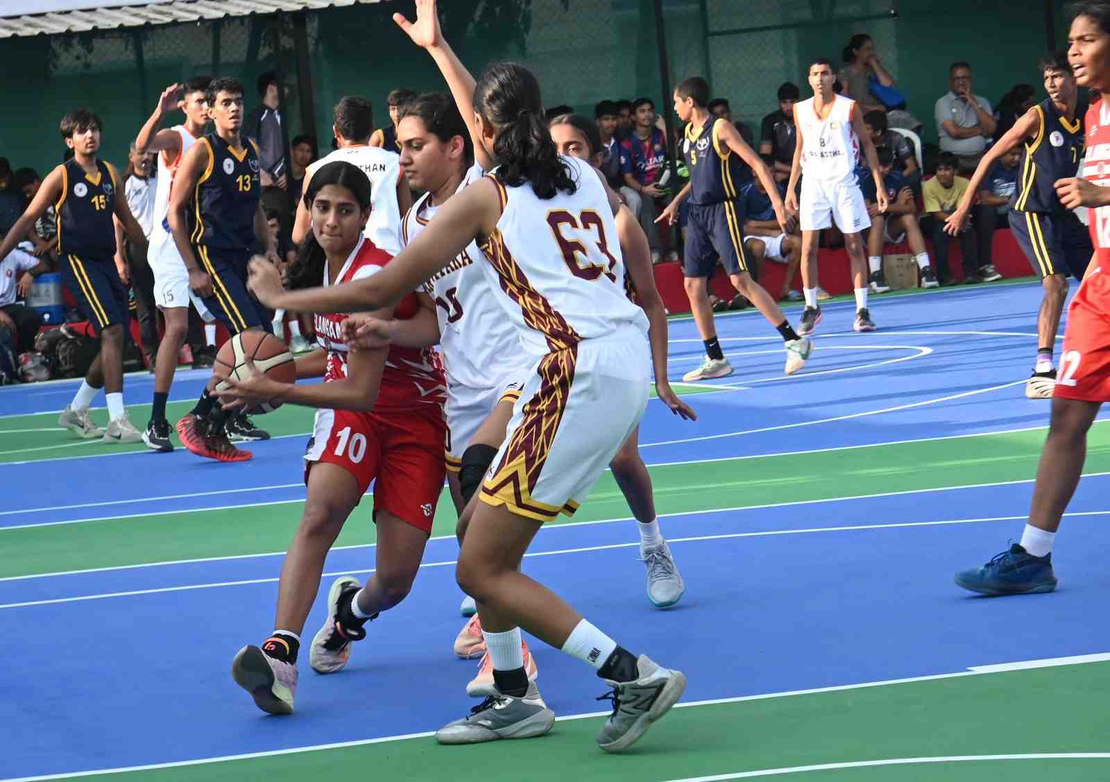 Telangana's Saanvi Kolisetty drives past a defender to score a basket against Karnataka in the 41st Youth National Basketball in Pune